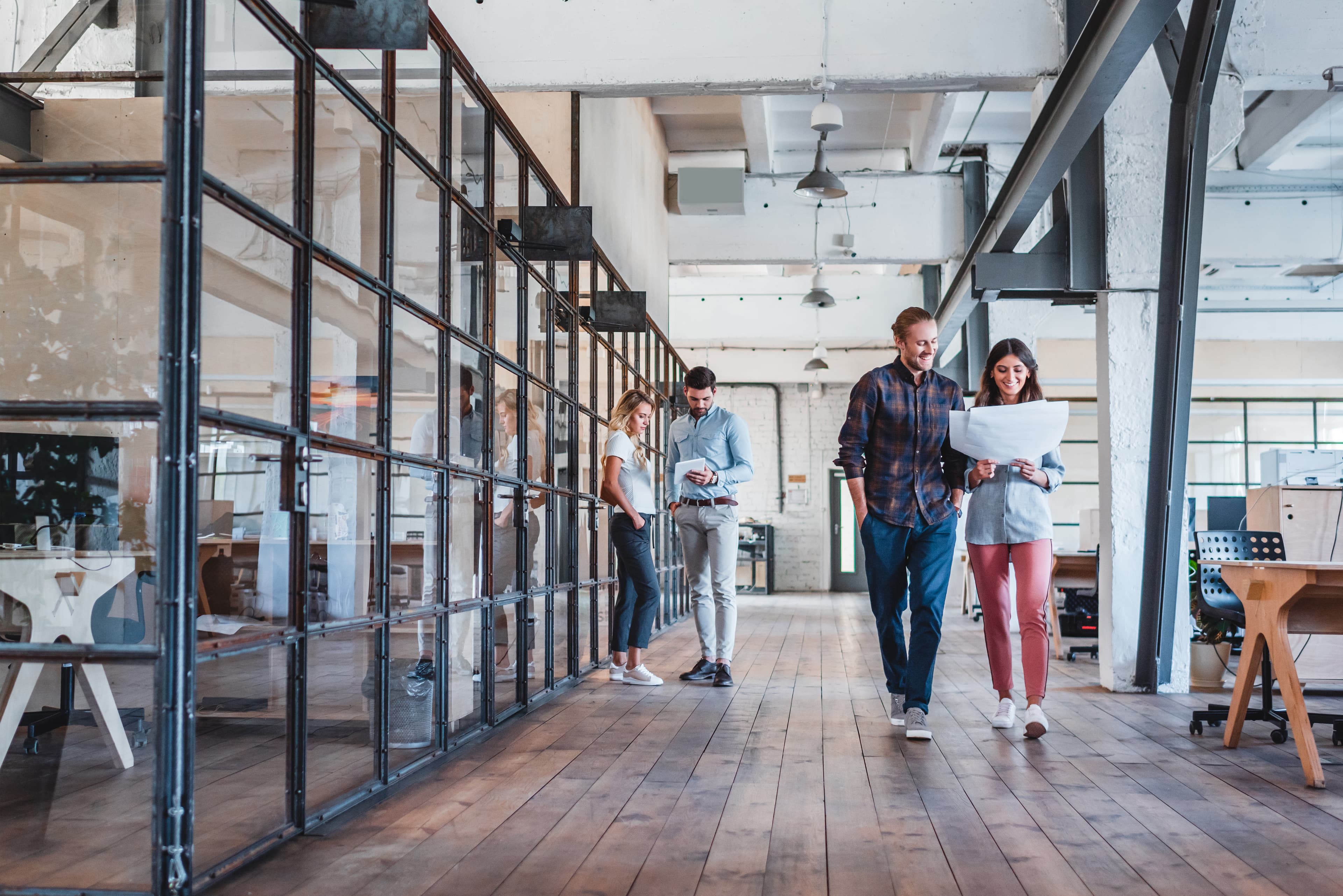 modern office space workplace people conversing in the hallway AdobeStock 229149676