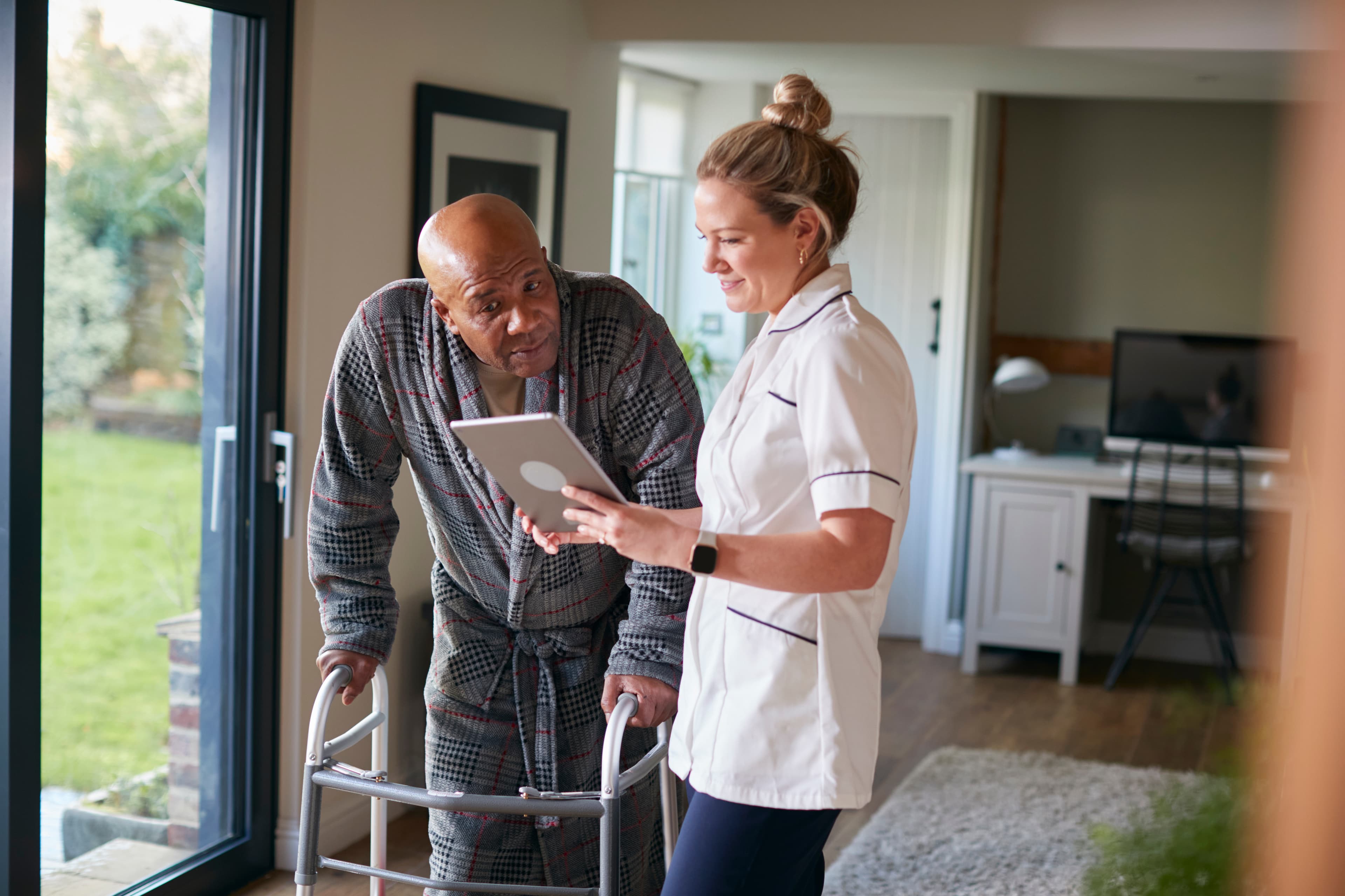 healthcare woman nurse assist man at home medical patient photograph AdobeStock 388267218