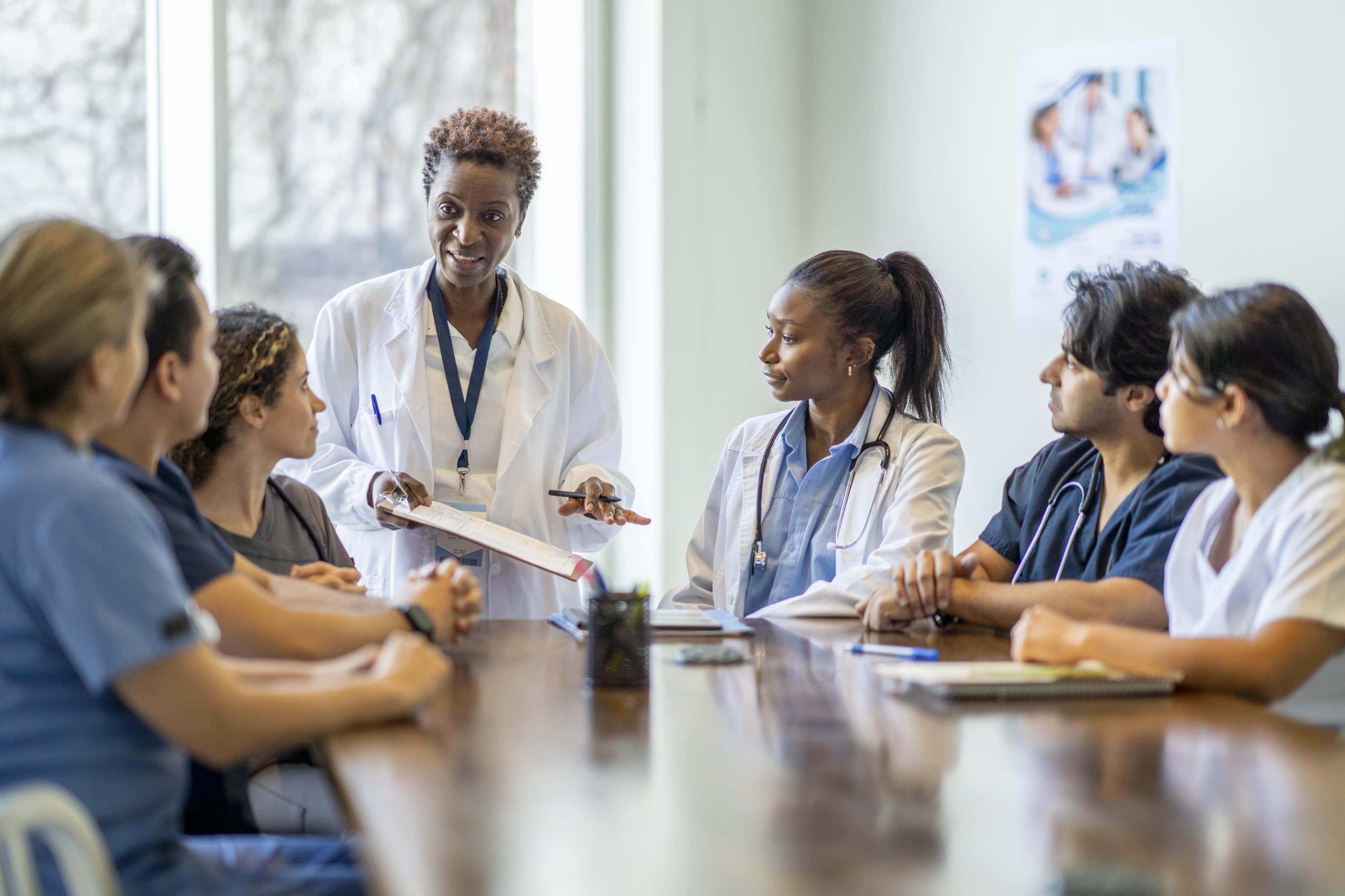 healthcare recruiting photography diverse group of doctors and nurses in meeting discussion iStock-1387152896