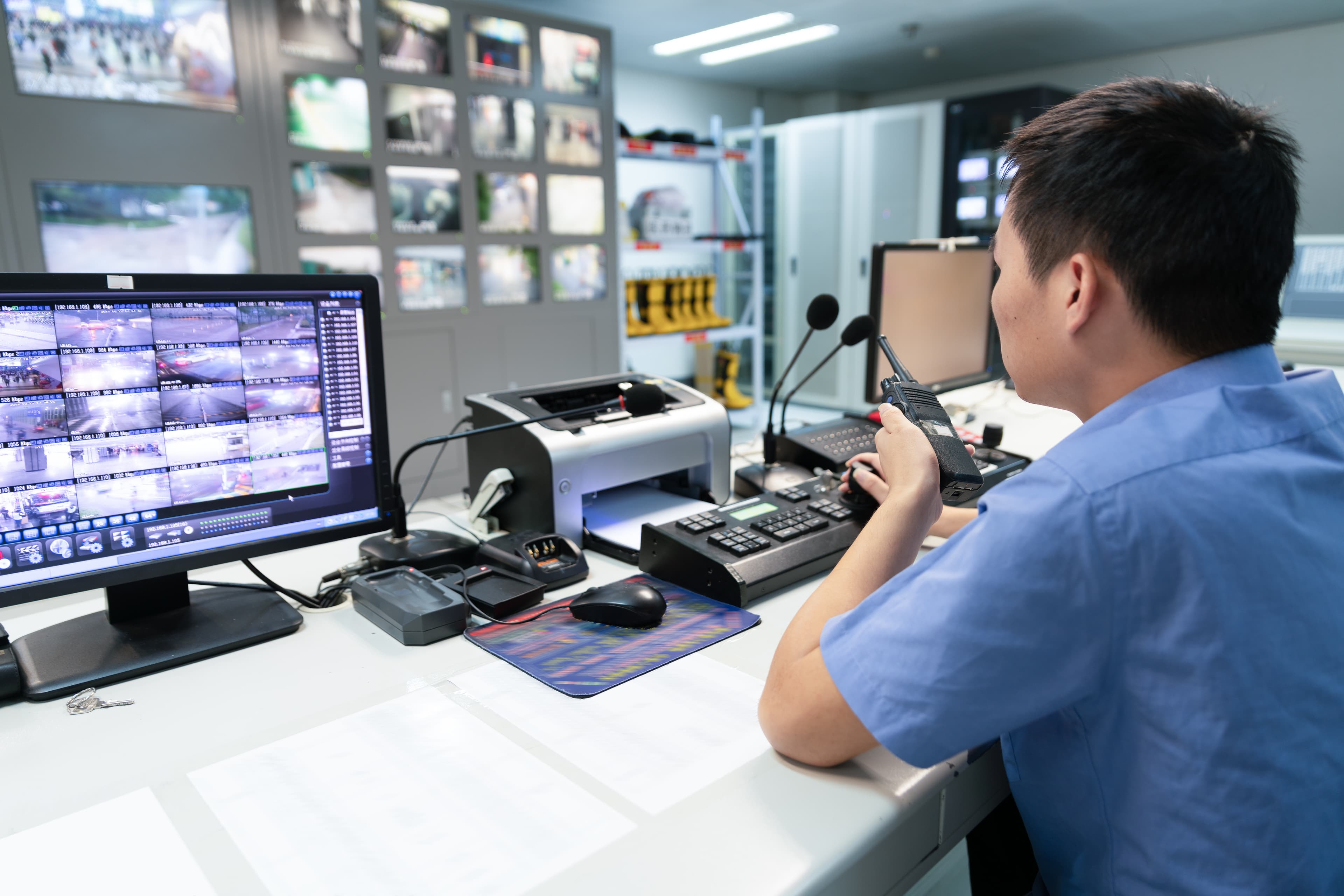 aerospace and defense A&D cleared candidates military man at high tech controls desk with walkie-talkie security clearance AdobeStock 285869277